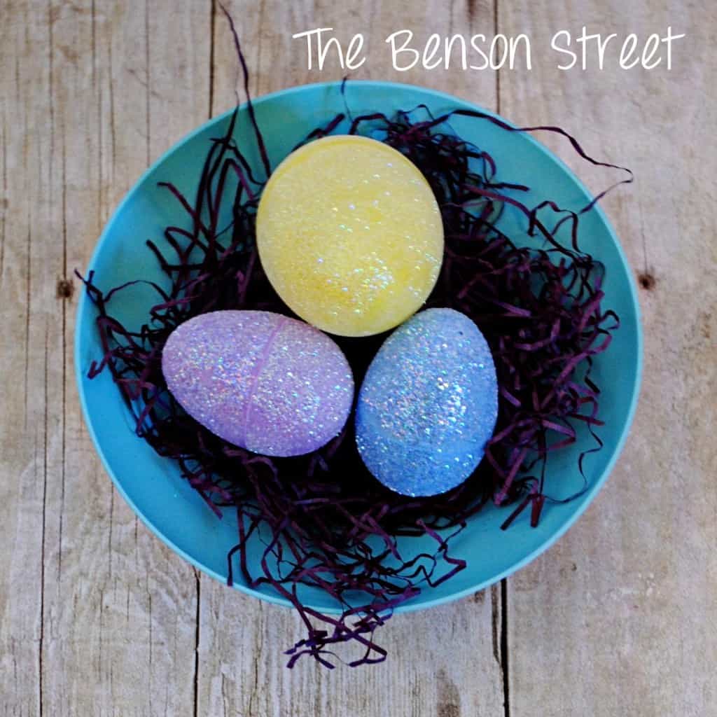 overhead shot of a bowl with plastic easter eggs with glitter on them