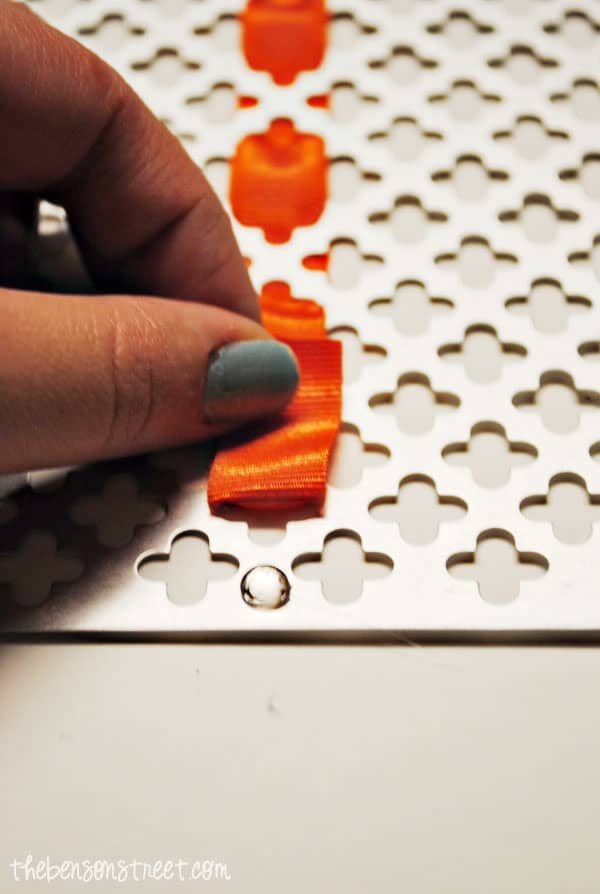 gluing ribbon to metal sign