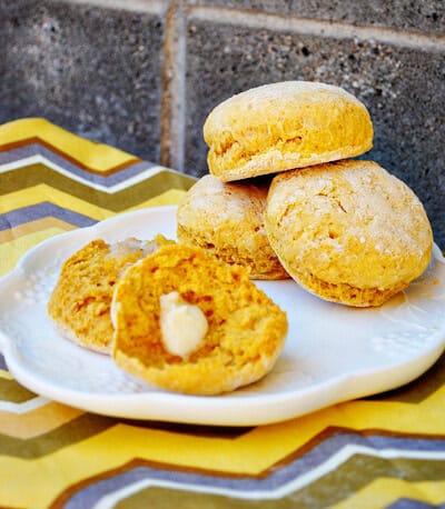 Quick recipe for pumpkin scones a fall side dish on a plate with one scone cut open with butter on it