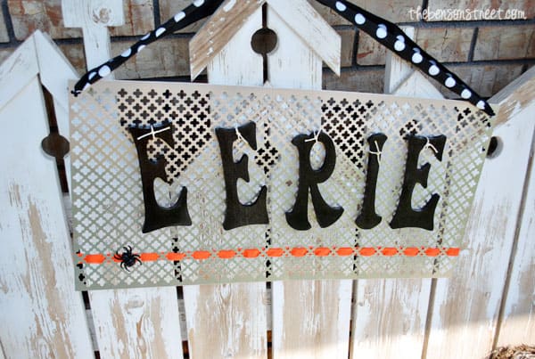 Outdoor halloween decor sign tutorial shown on a bench