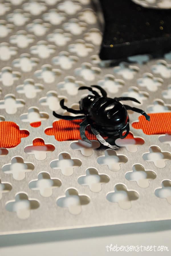 adding a spider to an eerie halloween sign