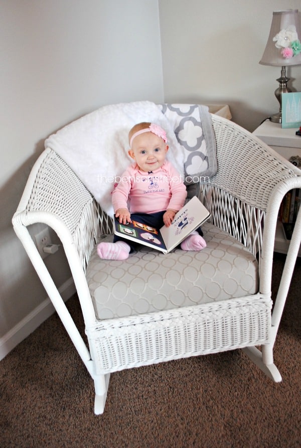 Enjoying Books in a cute girly nursery at thebensonstreet.com
