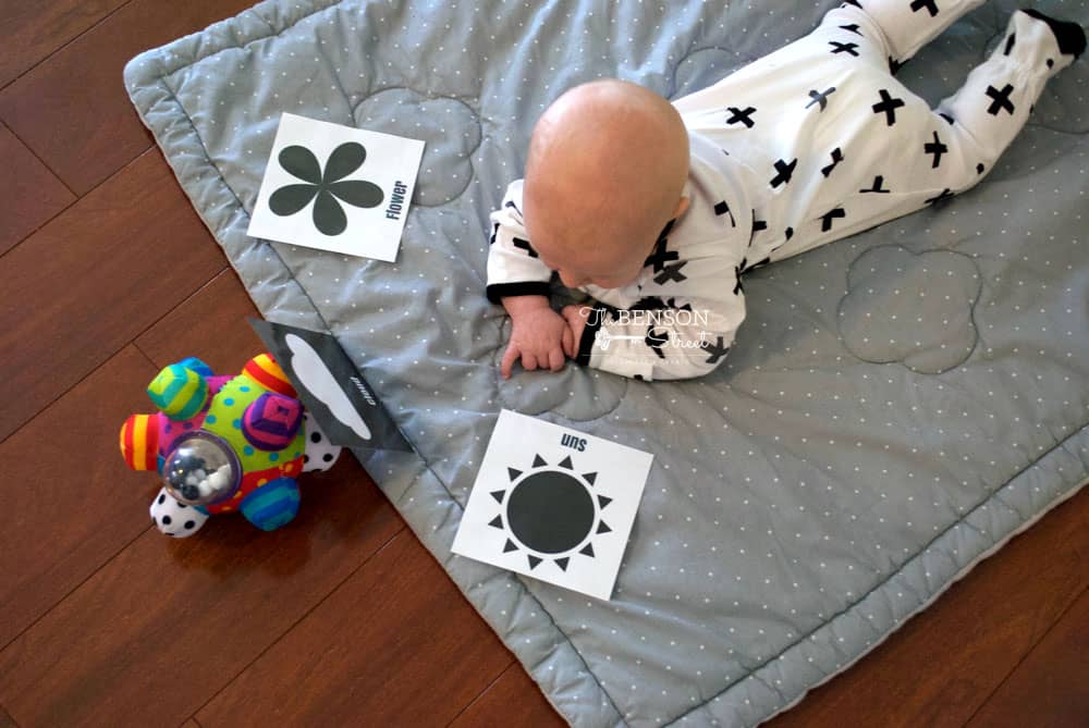 Black and white tummy time cards in use by a baby laying on tummy