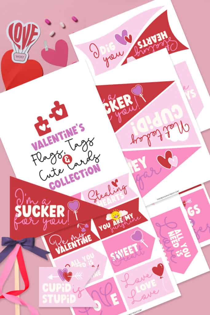Flat lay of pages of free printable printable valentines day tags, cards, and flags in binks, red,s and light purples.