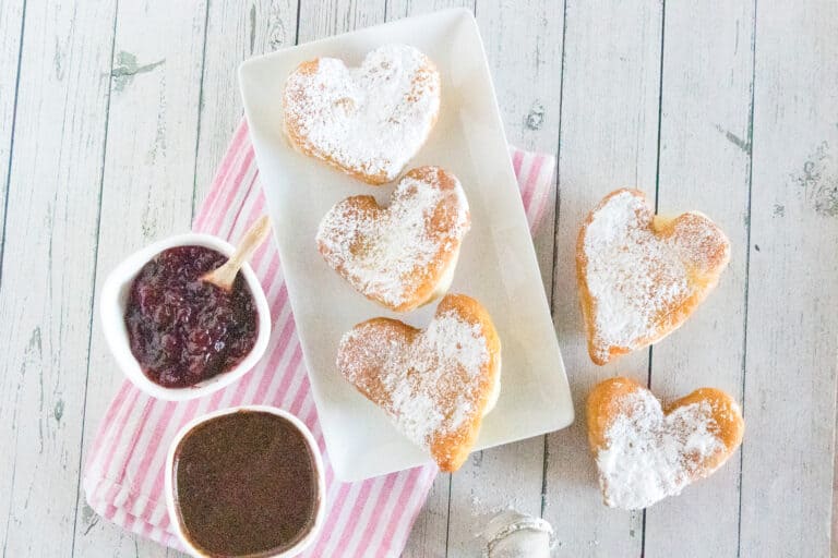 Valentine's Day breakfast idea of heart beignets with chocolate sauce