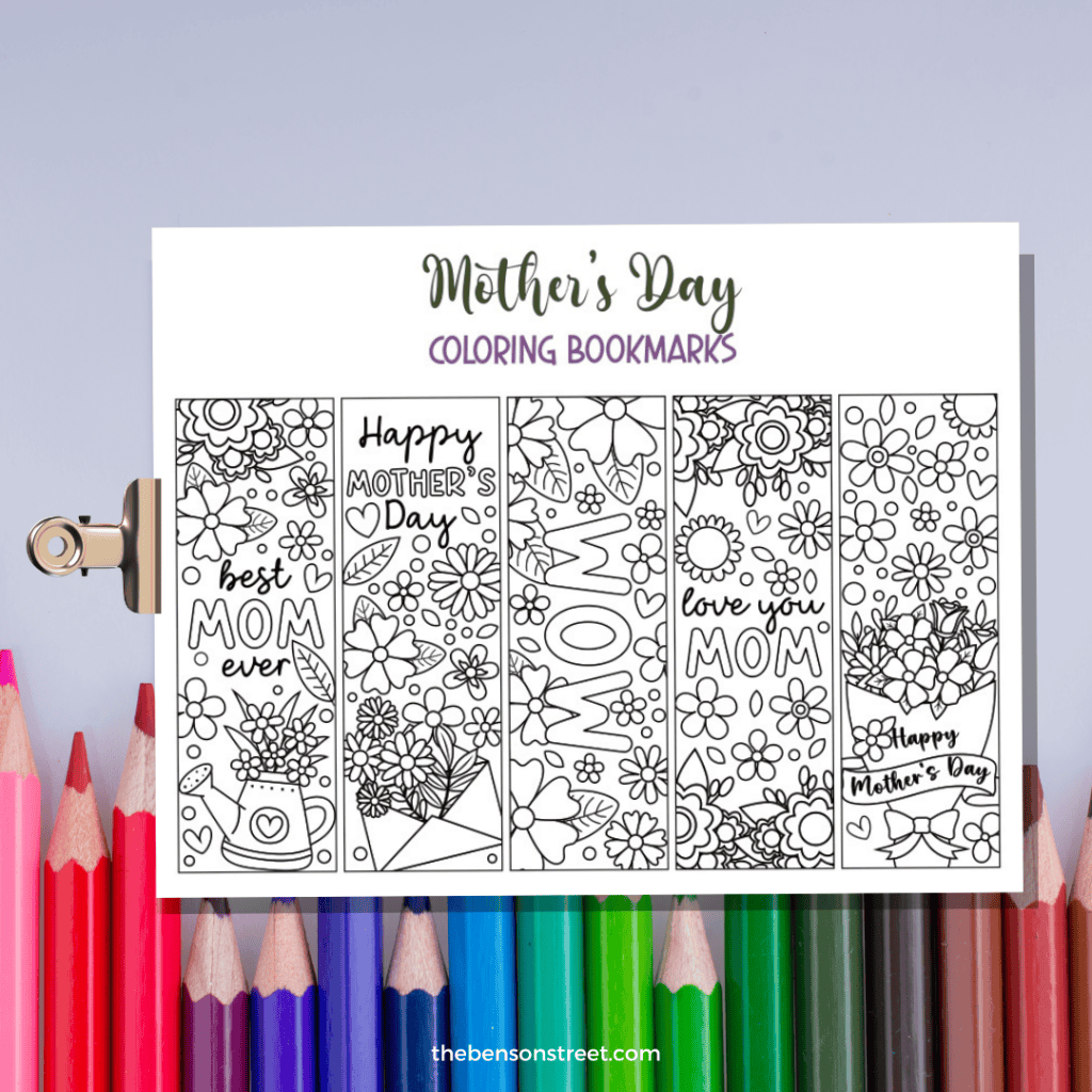A set of five free printable coloring bookmarks to color and personalize for Mother's Day gifting on a clipboard with colored pencils in the background.