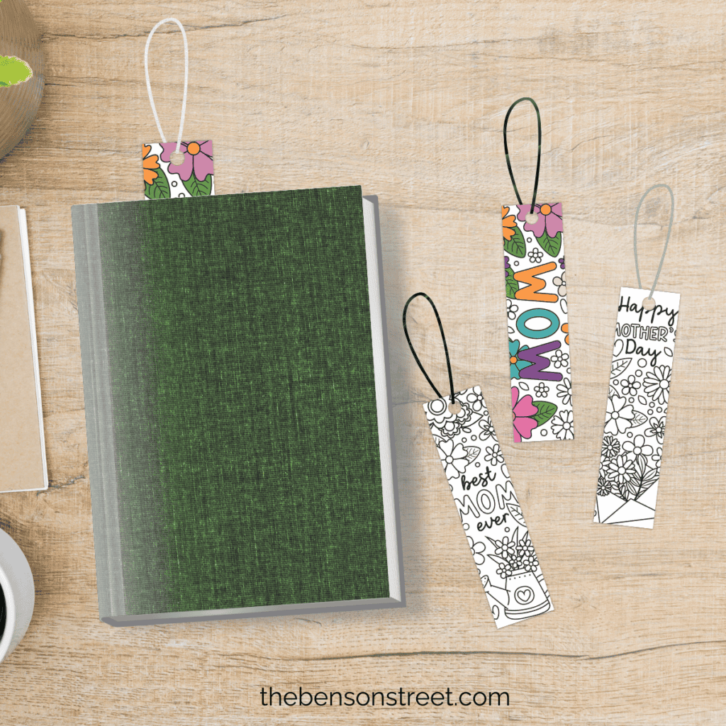 Several completed Mother's Day coloring bookmarks arranged on a table, showcasing a range of colors and designs.