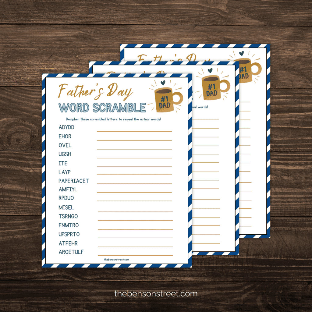 Stack of printed Father's Day Word Scramble puzzles on a dark wood background.