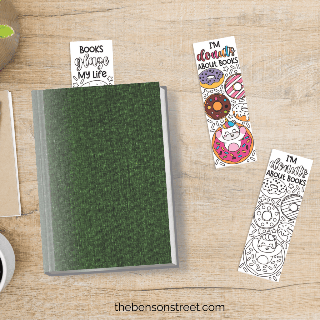 Three printable donut coloring bookmarks, one in a green book and two on a table beside the book.
