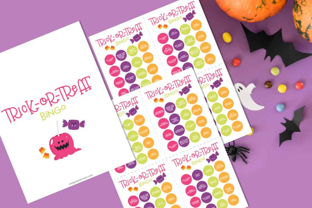 Flat lay of trick-or-treat bingo printable set of cards for Halloween.