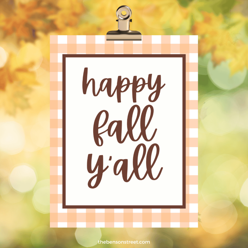 Clipboard with Happy Fall Y'all sign with orange and brown.