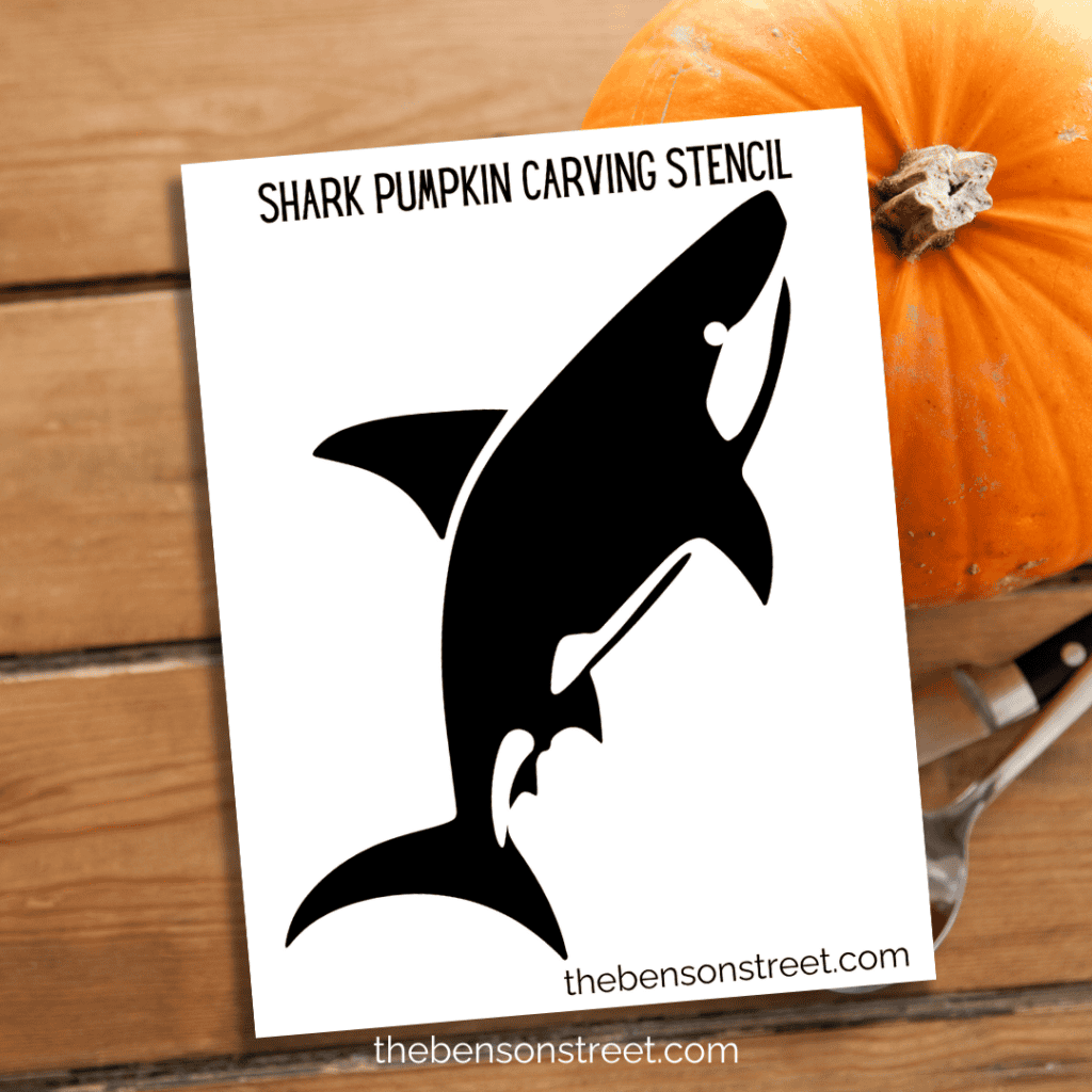 A printable stencil of a shark, perfectly aligned on a white background, ready to be transferred to a pumpkin for carving.