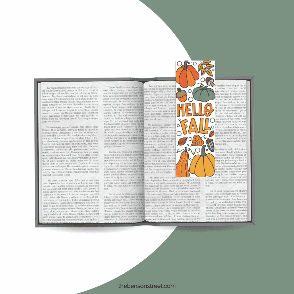A book laying open with the Hello Fall bookmark laying on the book.