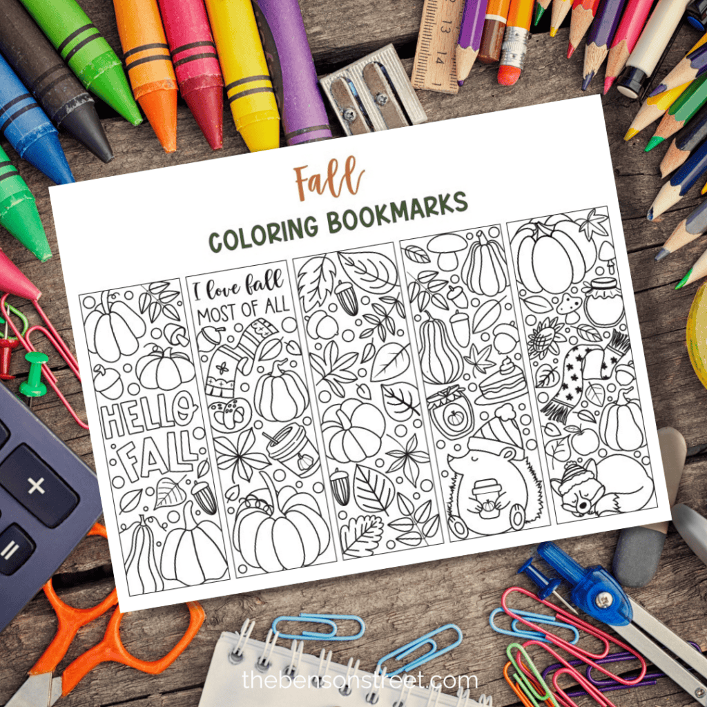 A sheet of printable fall coloring bookmarks with school supplies arranged around it.