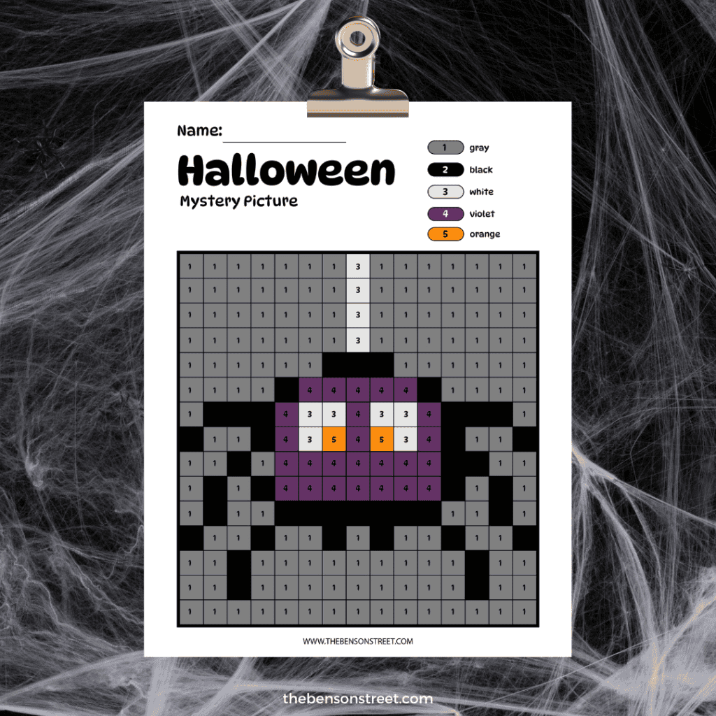 Clipboard with a free printable halloween mystery picture color by number grid colored in to show a spider.
