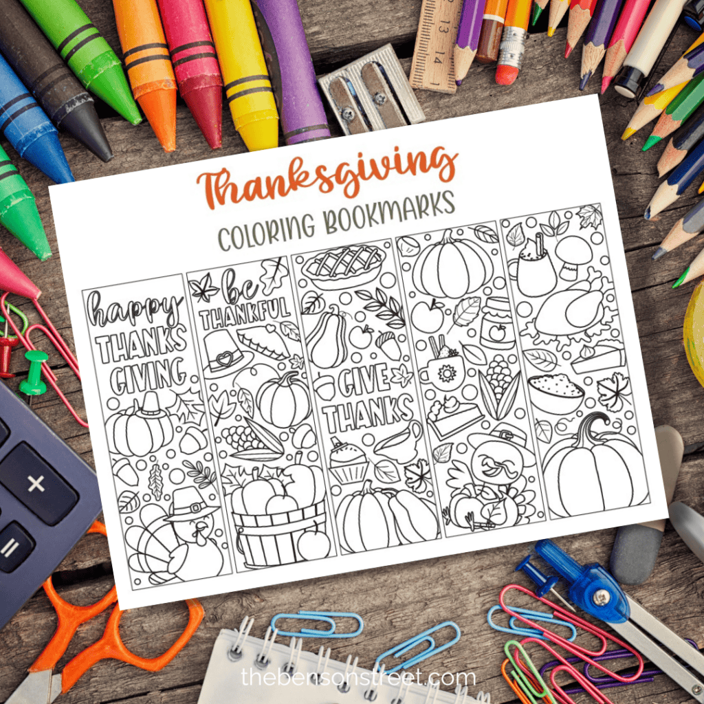 Page of thanksgiving coloring bookmarks printed out and laying on a desk with school supplies around.