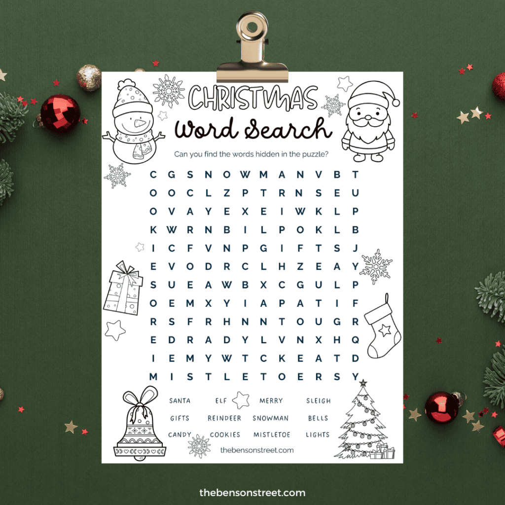 Black and white printable Christmas word search grid with hidden holiday words on clipboard