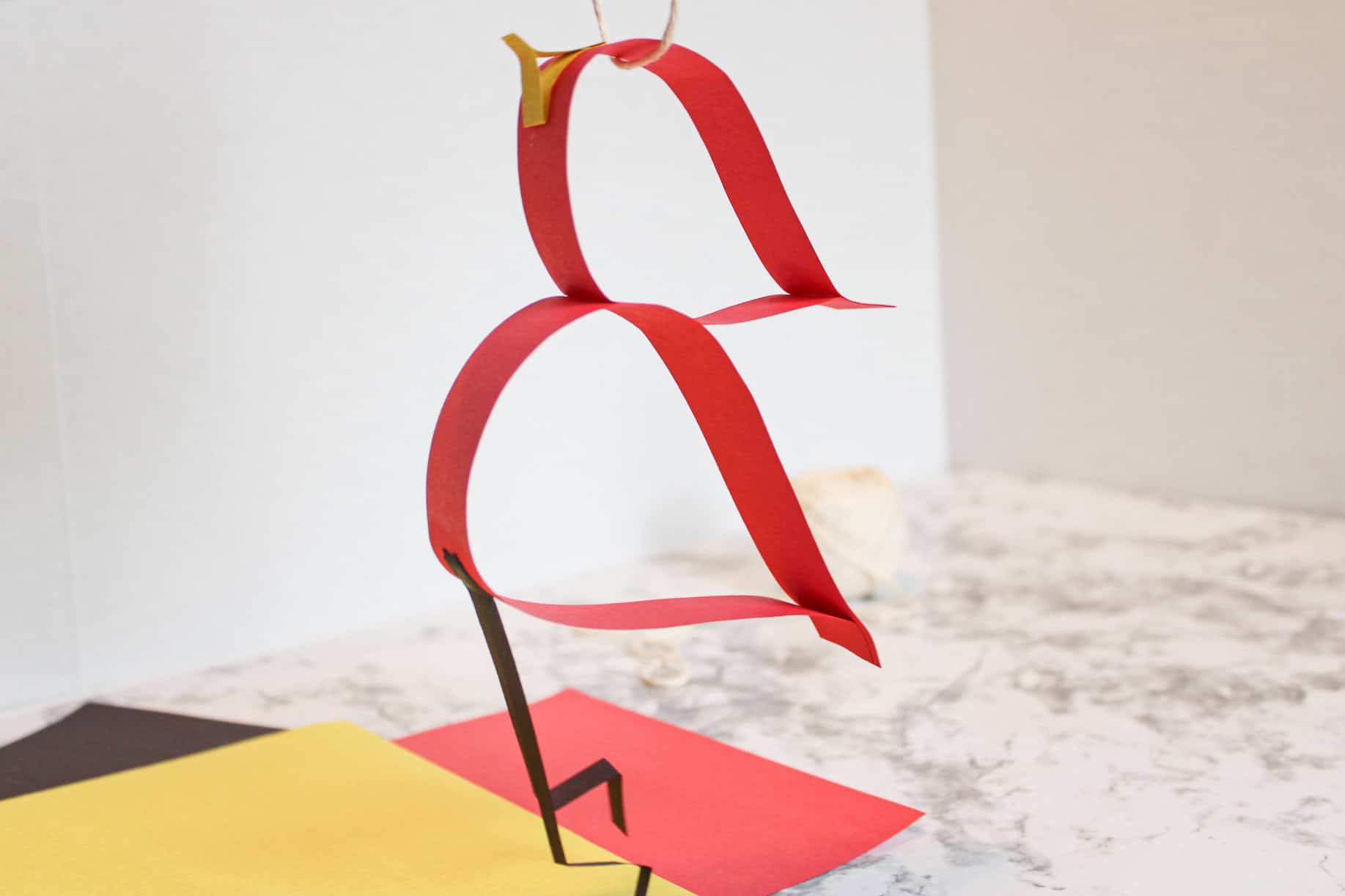 Hanging paper strip cardinal craft to make