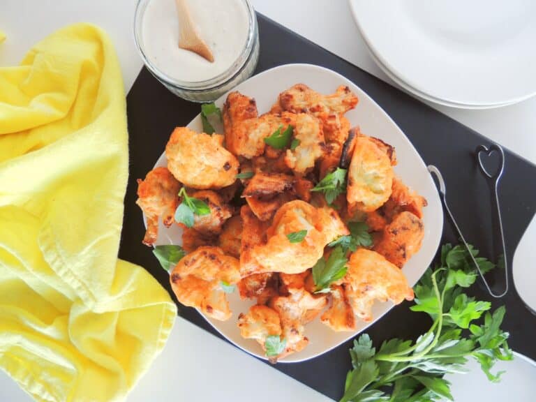 Homemade spicy cauliflower wings on a plate ready to eat garnished