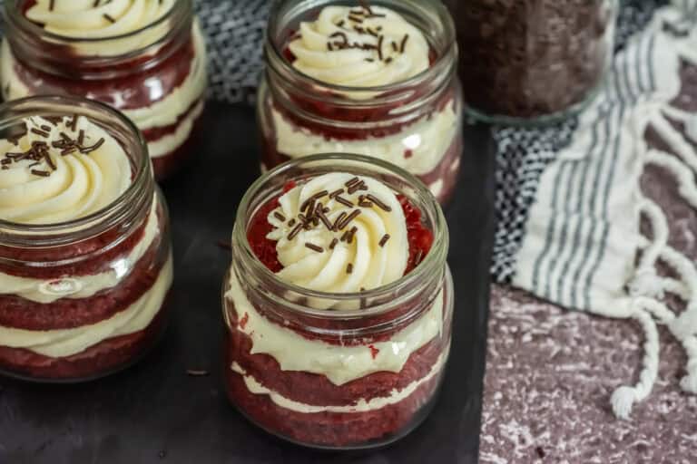 Side View of red velvet jar cakes with chocolate sprinkles on top