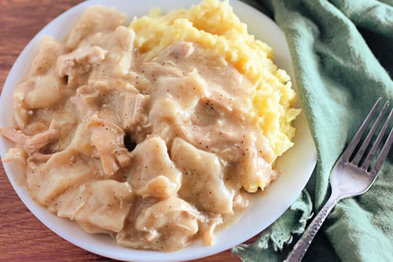 Plate of 30 minute Chicken and dumplings recipe over mashed potatoes