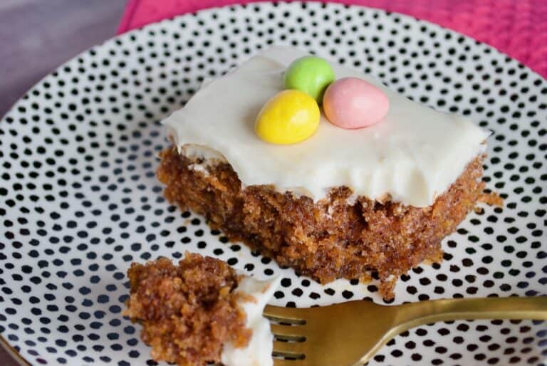 Up close of a piece of carrot cake with a bite taken out of it