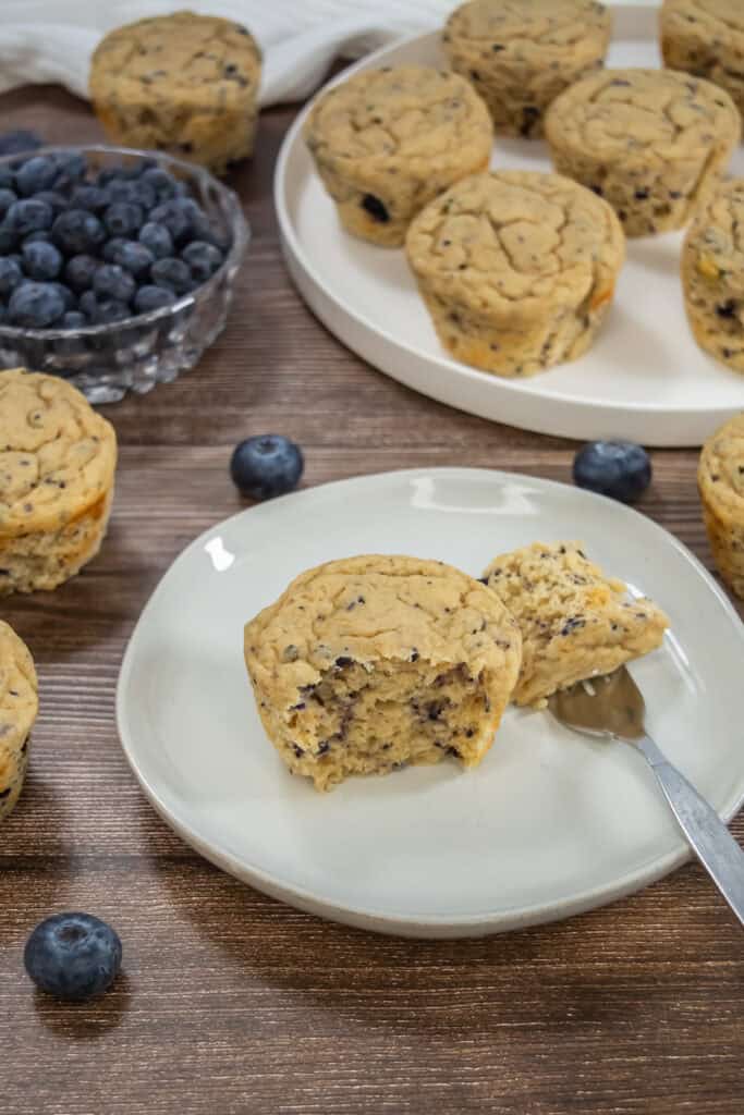 A high protein muffins recipe baked up and on a plate with a bite taken out of it