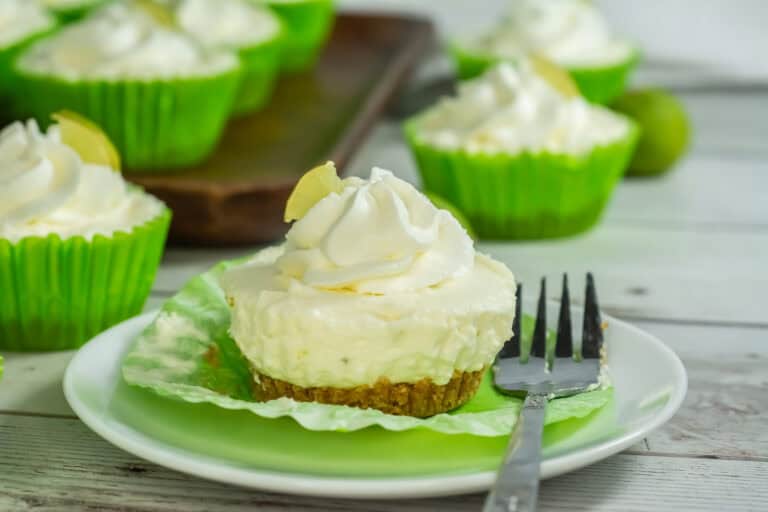 No bake key lime cheesecake on a white plate with fork next to it