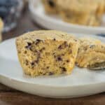 Upclose shot of a blueberry 3 ingredient protein muffin with a bite taken out of it