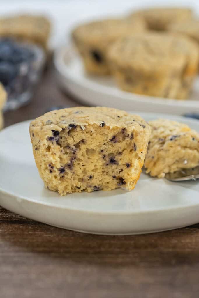 Upclose shot of a blueberry 3 ingredient protein muffin with a bite taken out of it
