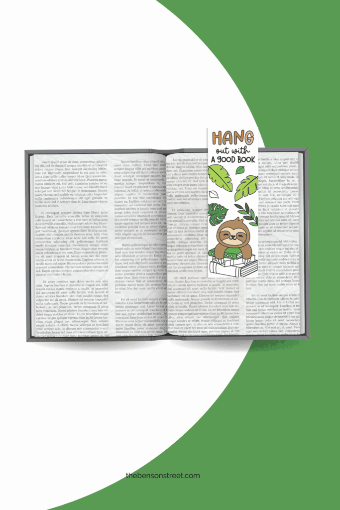 An open book with a colored in sloth coloring bookmark laying on top of the page