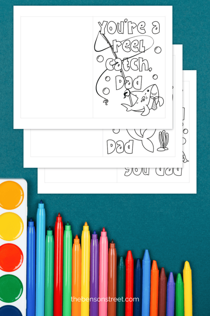 Free Coloring cards for father's day with a shark theme stacked on top of each other with markers along the bottom