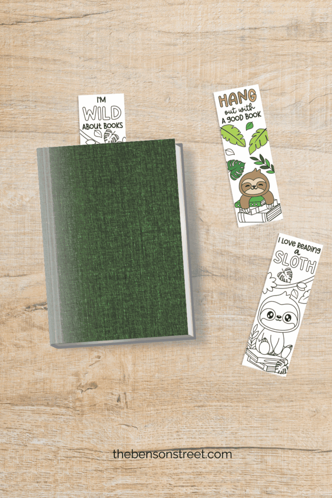 Hang out with a good book free printable sloth coloring bookmarks one sticking out of a book and other two laying beside the book