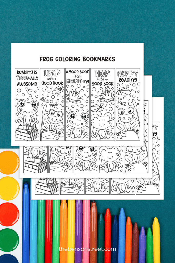 Three printed sheets of frog bookmarks to color with markers in the background