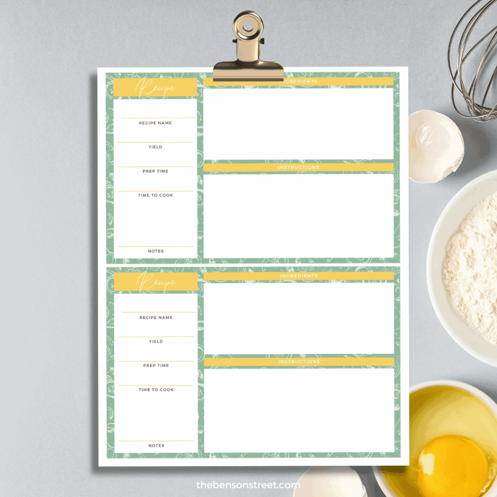 Clipboard with a page of printable recipe card templates with baking supplies in the background