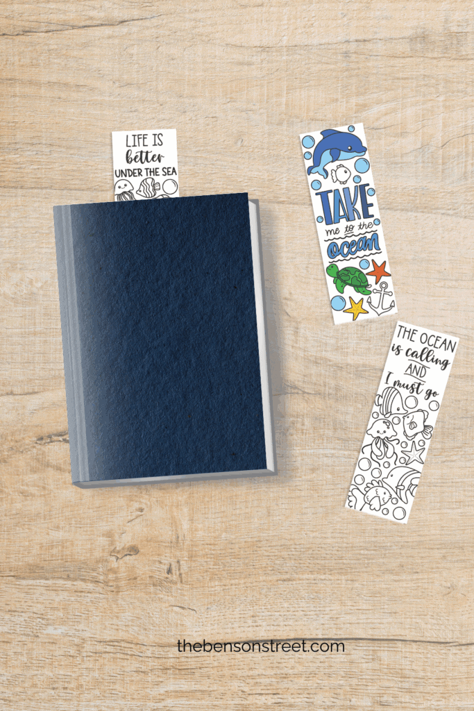Coloring bookmarks out to color in with one example in a book and one colored in laying next to it