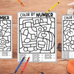 Three color by number sheets with crayons around them to color in on a long trip