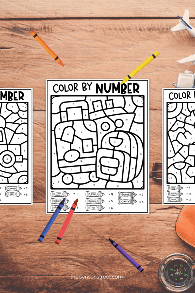 Three color by number sheets with crayons around them to color in on a long trip