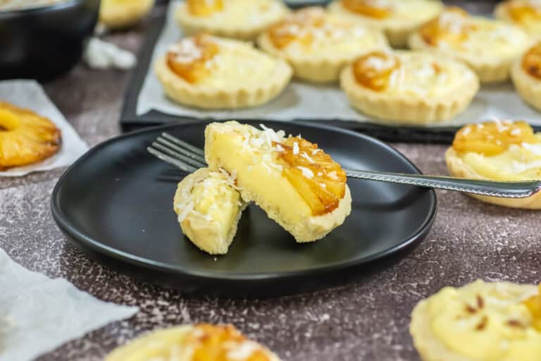 Upclose side view shot of a pineapple tart cut in half so you can see the filling inside