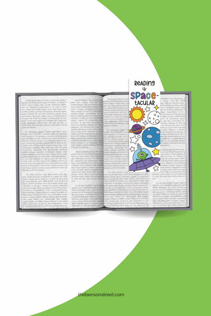 Colored in Space coloring bookmarks that says reading is space-tacular laying on top of an open book