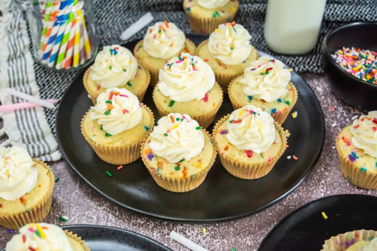 Plate full of confetti sprinkle cupcakes ready to eat