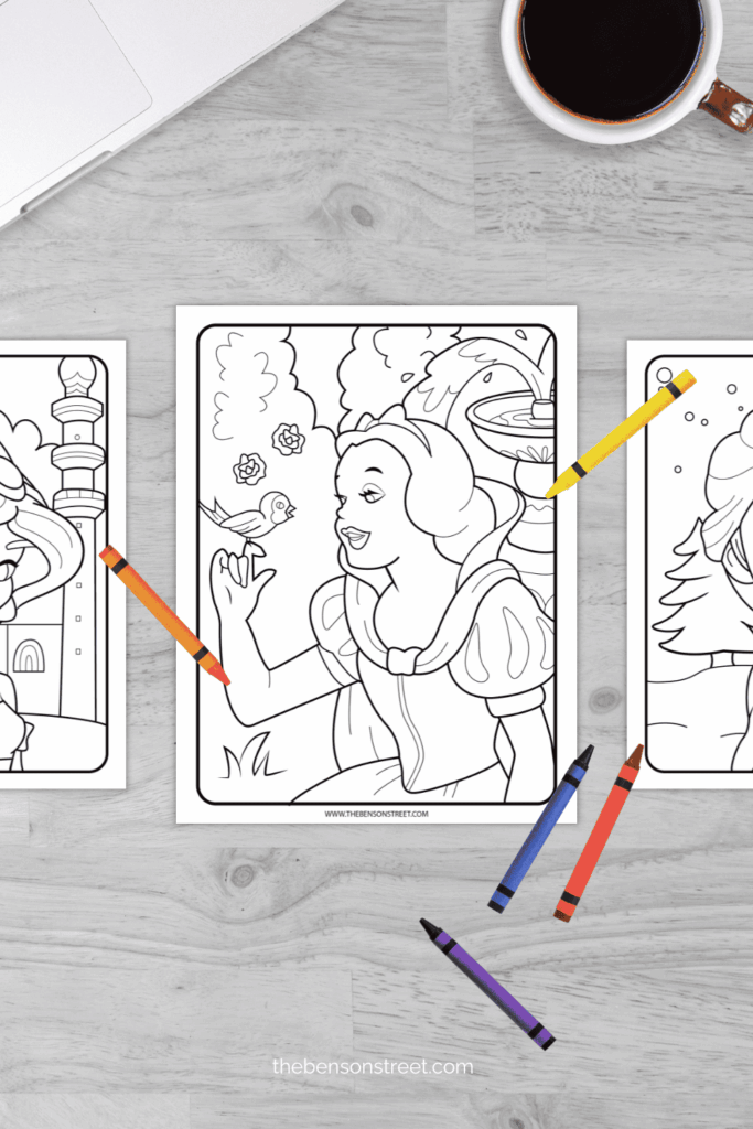 Snow White coloring page with crayons scattered around ready to color in on a table