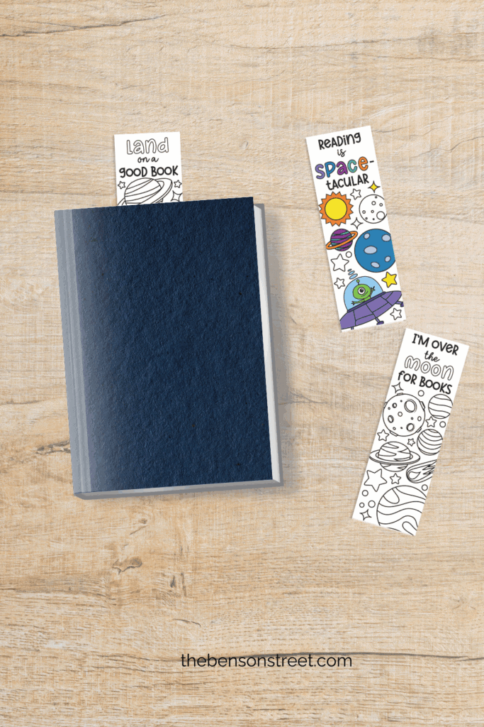 Space Themed bookmarks cut out and laying around a book