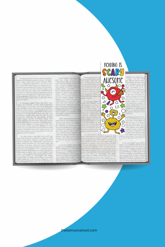 An open book with a colored in monster bookmark on the page to hold your place