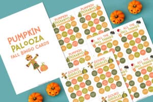 flat lay of fall activity bingo pages on a blue background