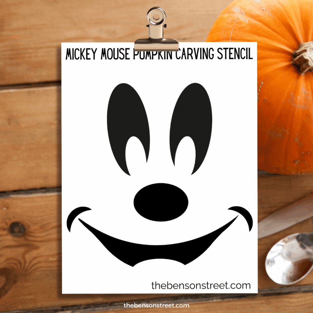 Mickey Mouse Pumpkin Carving Stencil template on a clipboard