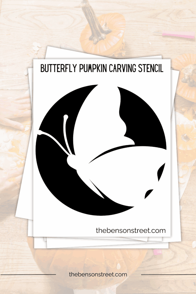 Stack of papers with a printed out butterfly pumpkin carving stencil