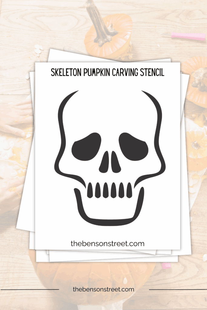 Stack of papers with a printed out skeleton pumpkin carving template stencil