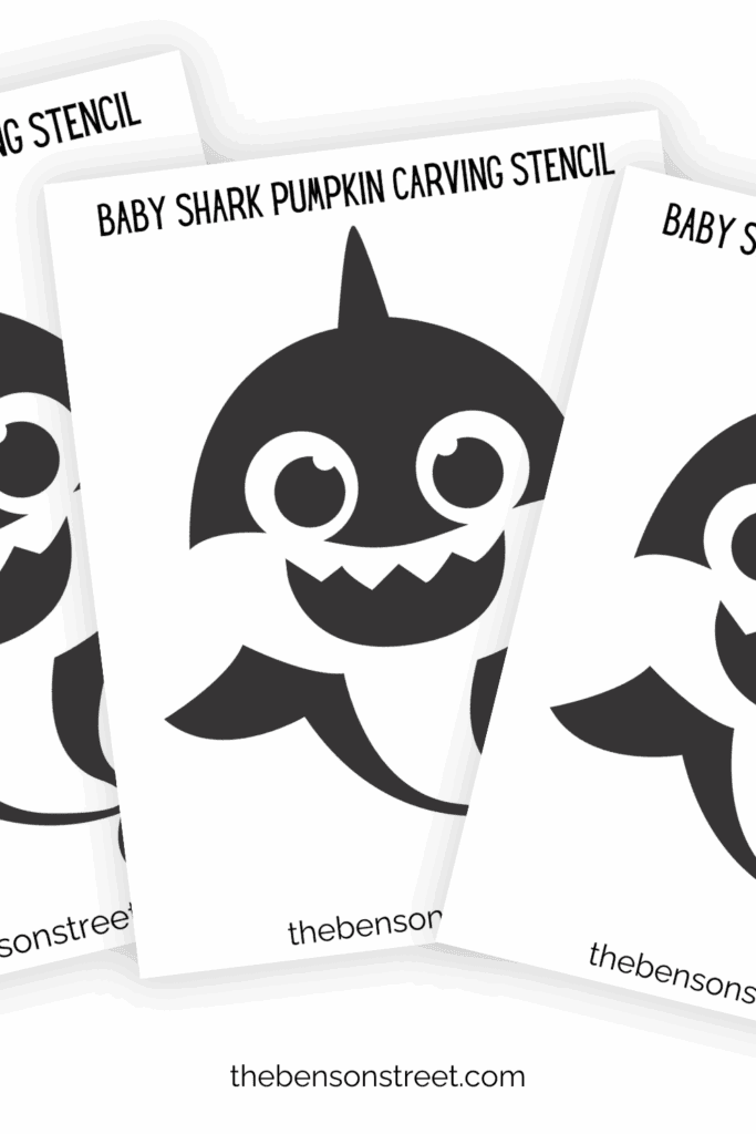 Three pages of baby shark pumpkin carving stencils in a fanned out stack