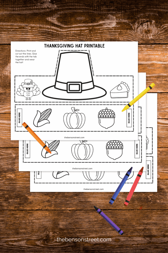 Three sheets of a free printable pilgrim hat headband with crayons on top 